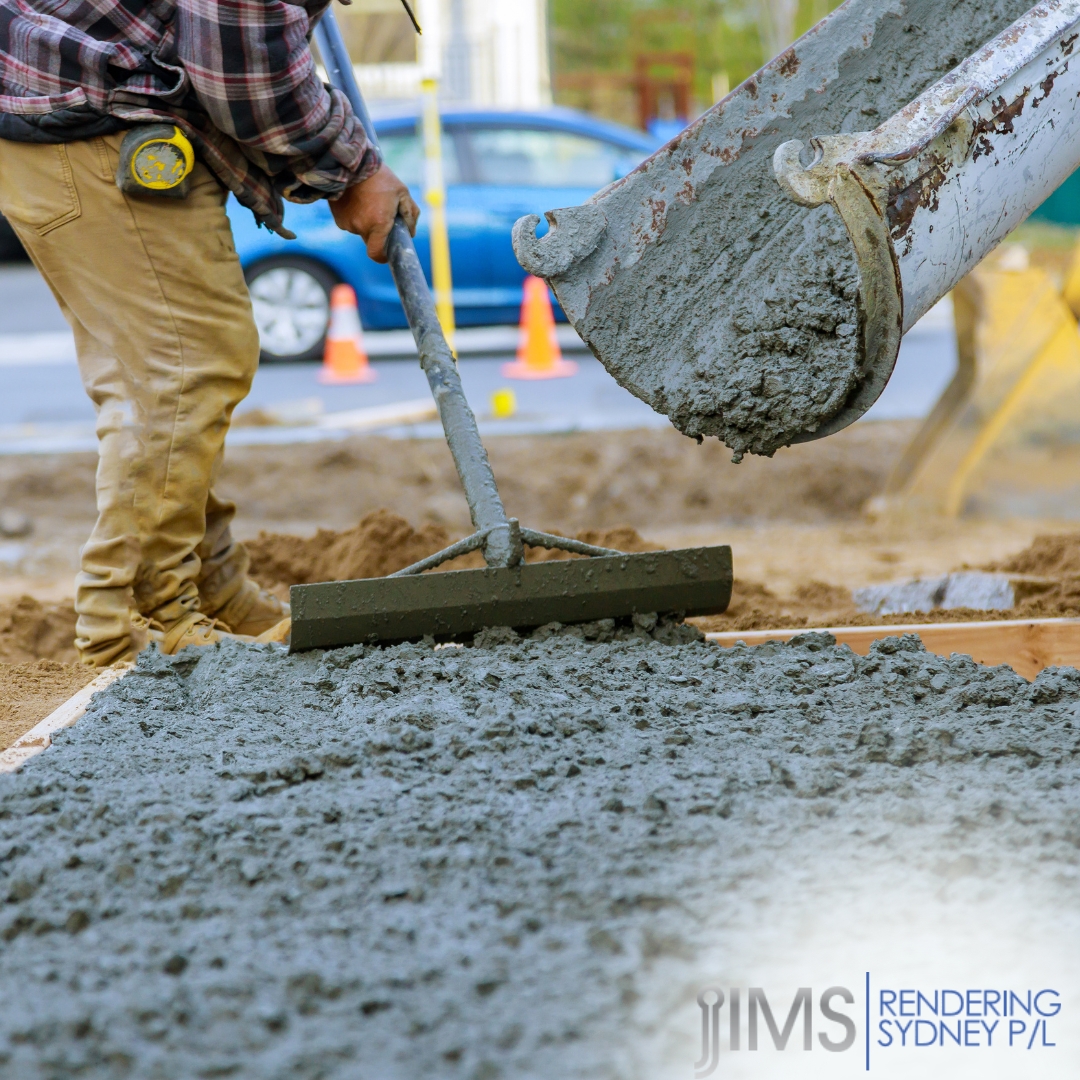 A man in brown pants is holding a shovel doing cement rendering in Sydney.